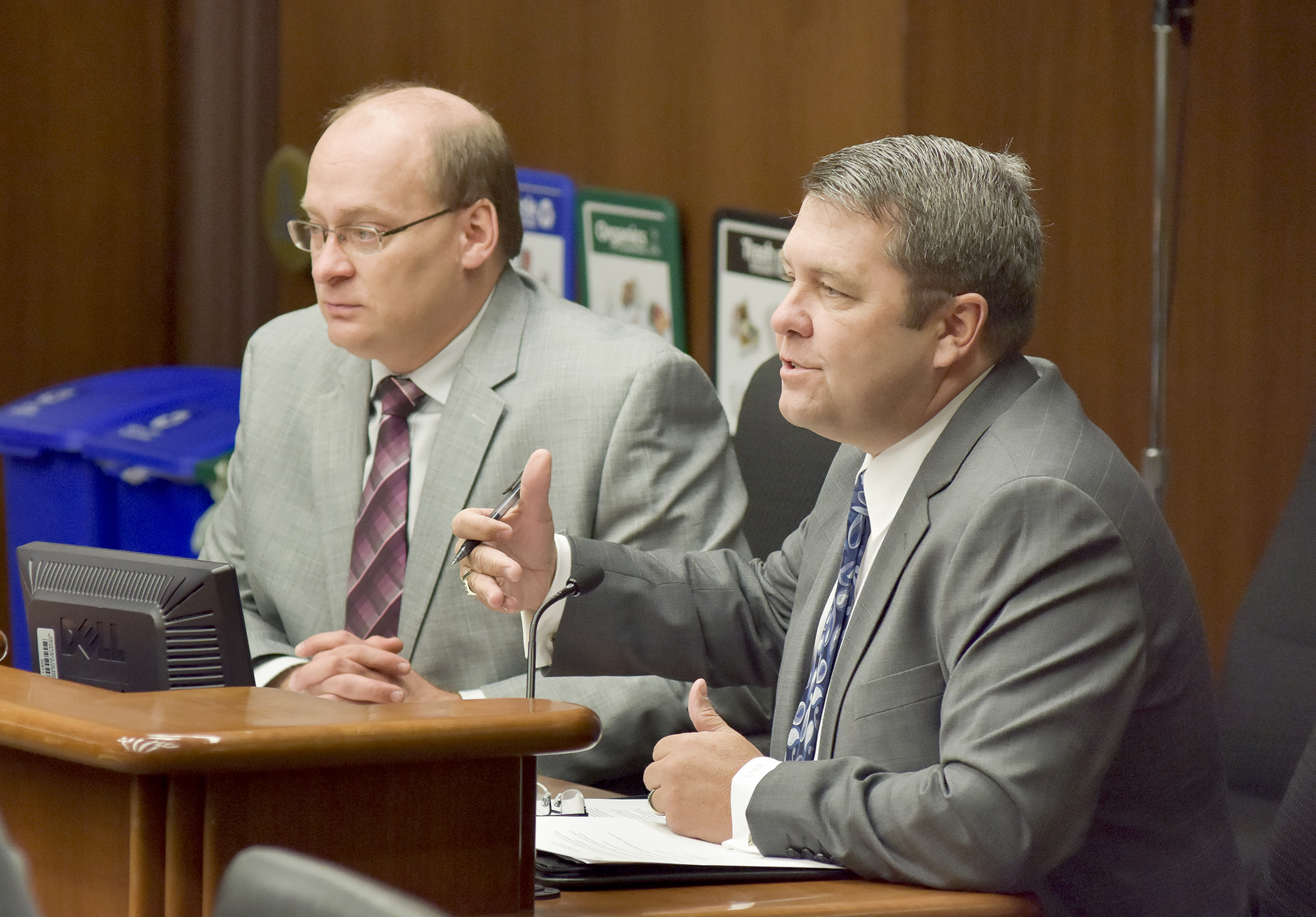 Representing the Minnesota Ambulance Association, Buck McAlpin testifies Jan. 26 before the House Health and Human Services Reform Committee in support of a bill sponsored by Rep. Jeff Backer, left, that would provide an interstate compact for the recognition of emergency medical service personnel licensure. Photo by Andrew VonBank